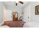 Bright bedroom with two twin beds, a ceiling fan, and wooden furniture at 308 W Whitaker Mill Rd, Raleigh, NC 27608