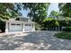 Wide driveway and oversized two-car garage showcasing beautiful landscaping and craftsman architecture at 308 W Whitaker Mill Rd, Raleigh, NC 27608