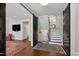 Inviting entryway with staircase, rugs, and modern sliding barn doors at 308 W Whitaker Mill Rd, Raleigh, NC 27608