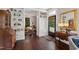 Inviting foyer with dark hardwood floors, white built-ins, and a vintage wooden desk at 308 W Whitaker Mill Rd, Raleigh, NC 27608