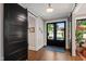 Grand foyer featuring sliding barn doors, a view to the backyard, and beautiful hardwood floors at 308 W Whitaker Mill Rd, Raleigh, NC 27608