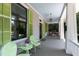 Charming porch seating with a light blue ceiling, green shutters, and white pillars at 308 W Whitaker Mill Rd, Raleigh, NC 27608