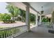 Inviting porch with white railings and pillars, a light blue ceiling, and green shutters at 308 W Whitaker Mill Rd, Raleigh, NC 27608
