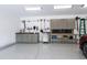 The garage showcases a clean epoxy floor, cabinetry, work bench, and well-organized storage solutions at 308 W Whitaker Mill Rd, Raleigh, NC 27608