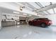 The garage showcases a clean epoxy floor, cabinetry, work bench, and a parking space with a vehicle parked at 308 W Whitaker Mill Rd, Raleigh, NC 27608