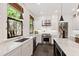 Modern kitchen featuring stone countertops, stainless appliances, and natural light from large windows at 308 W Whitaker Mill Rd, Raleigh, NC 27608