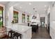 Bright kitchen with white cabinets, marble countertops, black island, and stainless steel appliances at 308 W Whitaker Mill Rd, Raleigh, NC 27608
