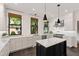 Modern kitchen with white subway tile backsplash, marble counters, and stainless steel appliances at 308 W Whitaker Mill Rd, Raleigh, NC 27608