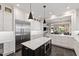 Spacious kitchen with a central island, stainless steel appliances, and ample cabinet space at 308 W Whitaker Mill Rd, Raleigh, NC 27608