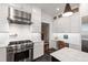Bright kitchen featuring a stainless steel range hood, white cabinets, and a built-in desk area at 308 W Whitaker Mill Rd, Raleigh, NC 27608