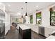 Open kitchen featuring an island, stainless steel appliances, and seamless access to dining area at 308 W Whitaker Mill Rd, Raleigh, NC 27608