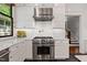 Contemporary kitchen boasting white cabinets, marble countertops, and stainless steel range at 308 W Whitaker Mill Rd, Raleigh, NC 27608