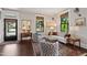 Bright living room with hardwood floors, neutral colors, and patterned armchairs at 308 W Whitaker Mill Rd, Raleigh, NC 27608