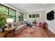 Bright living room featuring large windows, a comfortable sofa, and stylish decor at 308 W Whitaker Mill Rd, Raleigh, NC 27608