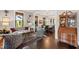 Bright living room with hardwood floors and a view into the dining room and kitchen at 308 W Whitaker Mill Rd, Raleigh, NC 27608