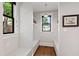 Stylish mud room with built-in bench seating, storage shelves, natural light, and decorative artwork at 308 W Whitaker Mill Rd, Raleigh, NC 27608