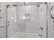Contemporary shower featuring glass doors, sleek hardware, and subway tile at 308 W Whitaker Mill Rd, Raleigh, NC 27608