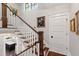 Elegant staircase features wooden steps, white risers, and a classic wood railing, leading to the upper levels at 308 W Whitaker Mill Rd, Raleigh, NC 27608
