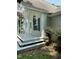 A covered back porch with steps and white pillars for a peaceful outdoor area at 3298 Oakridge Dr # A, Graham, NC 27253