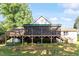 Charming backyard showcasing a raised wooden porch and lush greenery at 3298 Oakridge Dr # A, Graham, NC 27253