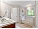 Bathroom with a tub, double sink, and a window above the tub at 3298 Oakridge Dr # A, Graham, NC 27253