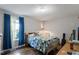 This bedroom features hardwood floors, a window with blue curtains, and musical instruments at 3298 Oakridge Dr # A, Graham, NC 27253
