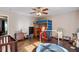 This bedroom features wood floors, a loft bed, a crib, and a ceiling fan at 3298 Oakridge Dr # A, Graham, NC 27253