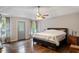 Spacious main bedroom with hardwood floors, a ceiling fan, and lots of natural light at 3298 Oakridge Dr # A, Graham, NC 27253