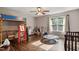 This bedroom features wood floors, large windows, a loft bed, and a ceiling fan at 3298 Oakridge Dr # A, Graham, NC 27253