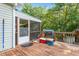 This deck features wood floors, a grill, and a view of the wooded yard at 3298 Oakridge Dr # A, Graham, NC 27253