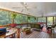 This screened deck features wood floors, wicker furniture, and a view of the wooded yard at 3298 Oakridge Dr # A, Graham, NC 27253