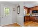 Inviting entryway leading to the kitchen with hardwood floors and stained glass door at 3298 Oakridge Dr # A, Graham, NC 27253