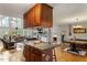 Open concept kitchen with island, wood floors and cabinets, and views to the living room at 3298 Oakridge Dr # A, Graham, NC 27253