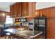 Well-appointed kitchen with stainless steel appliances, custom cabinets, and a mosaic-tiled island at 3298 Oakridge Dr # A, Graham, NC 27253