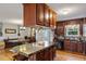 Open kitchen and dining area with stainless appliances, an island, and custom wood cabinets at 3298 Oakridge Dr # A, Graham, NC 27253