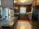 Well-lit kitchen features wood cabinets, black appliances, and a large island with seating at 3298 Oakridge Dr # A, Graham, NC 27253