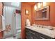 Charming bathroom with a marble countertop vanity, patterned shower curtain, and warm lighting at 352 Weymouth Close, Pittsboro, NC 27312