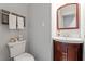 Cozy powder room features a sink with vanity and a toilet with white towels nearby at 352 Weymouth Close, Pittsboro, NC 27312