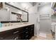 Bathroom featuring a double sink vanity with modern finishes, mirror, and laundry units at 352 Weymouth Close, Pittsboro, NC 27312