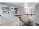 Upper-level hallway decorated with art, featuring a view down to the lower level at 352 Weymouth Close, Pittsboro, NC 27312