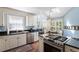 Stylish kitchen with stainless steel appliances, granite countertops, and hardwood floors at 352 Weymouth Close, Pittsboro, NC 27312