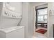 Laundry area with stacked washer and dryer, next to a bedroom at 352 Weymouth Close, Pittsboro, NC 27312