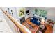 Open living room features a fireplace, window seat, hardwood floors, and plush seating at 352 Weymouth Close, Pittsboro, NC 27312