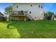 Backyard featuring a wooden deck, grassy lawn, and the house's exterior at 3712 Old Coach Rd, Raleigh, NC 27616