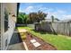 Backyard featuring a garden and lush lawn, with a wooden fence and tree at 401 Wyndham Drive, Fuquay Varina, NC 27526