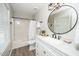 Bright bathroom featuring white cabinets, modern fixtures, and a shower-tub combination at 401 Wyndham Drive, Fuquay Varina, NC 27526