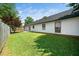 Rear exterior view of home, with manicured lawn, and mature shade trees at 401 Wyndham Drive, Fuquay Varina, NC 27526
