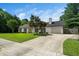 Classic home with manicured lawn, mature landscaping, and a welcoming driveway at 401 Wyndham Drive, Fuquay Varina, NC 27526