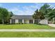 Charming single-story home with manicured lawn, mature tree, and welcoming curb appeal at 401 Wyndham Drive, Fuquay Varina, NC 27526