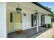 Inviting front porch with flower baskets and a cute 'Oh Hello' welcome mat at 401 Wyndham Drive, Fuquay Varina, NC 27526